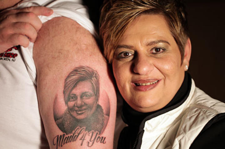 It's pretty accurate! Maddalena poses next to her likeness on Mauro's arm.