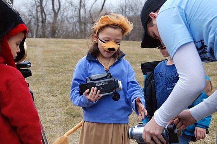 Sam of Movie Makers shows Alexis how to operate a camera.
