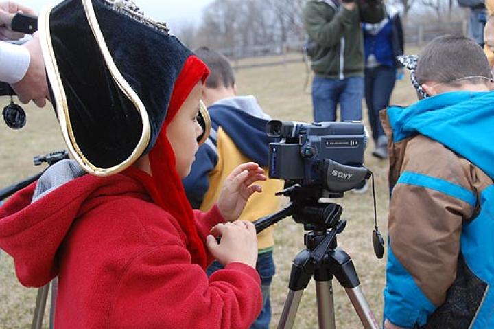 Collin learns how to use a camera from Sam of Movie Makers.