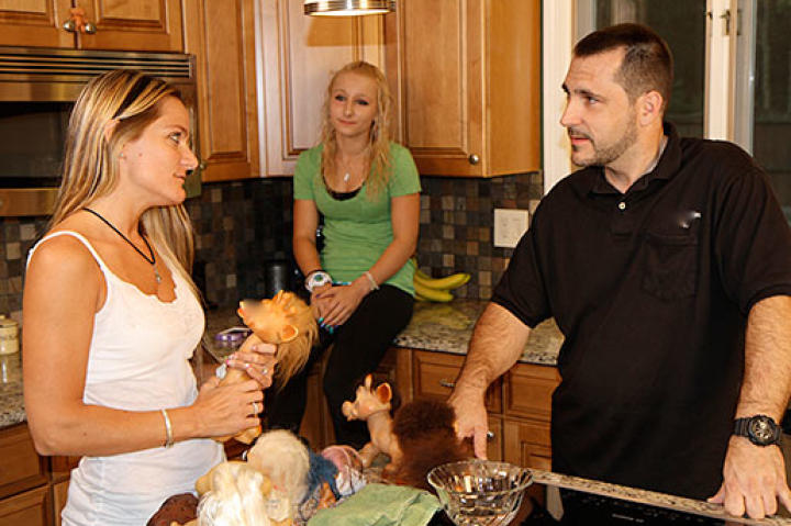 Michelle and her family are discussing where to put her newly purchased troll dolls.