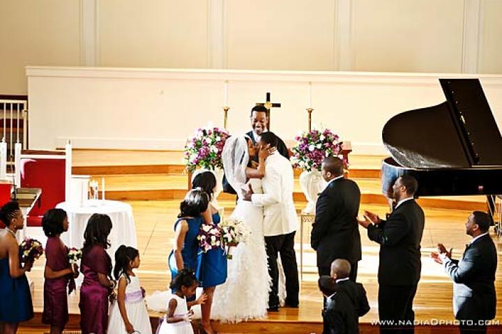 Asha and her groom, Bryson, embrace at the altar.