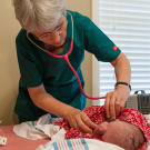 The midwife checks out Marcus.