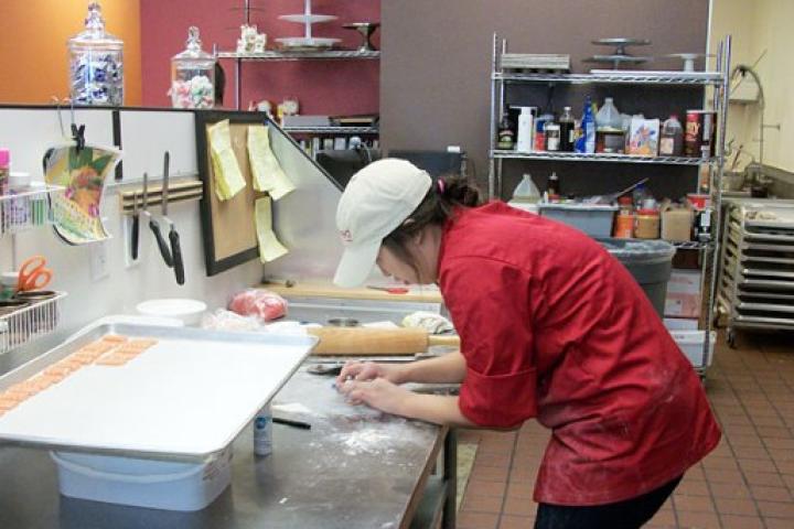 A cake decorator at Caked Las Vegas preparing sushi pieces made of cake.