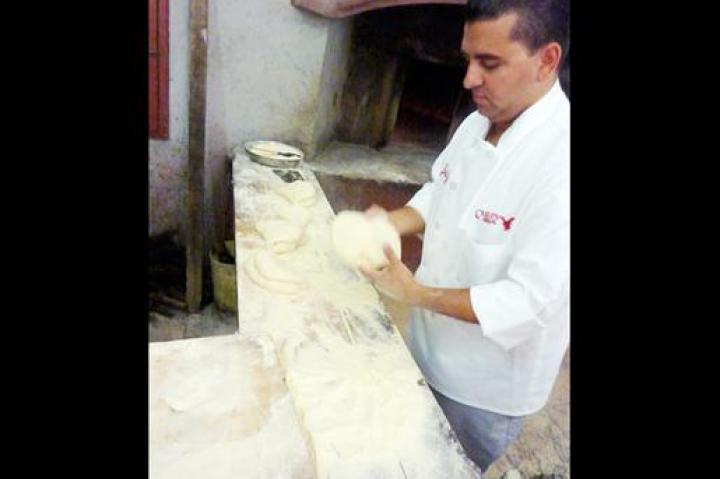 Buddy kneads bread dough in Altamura.