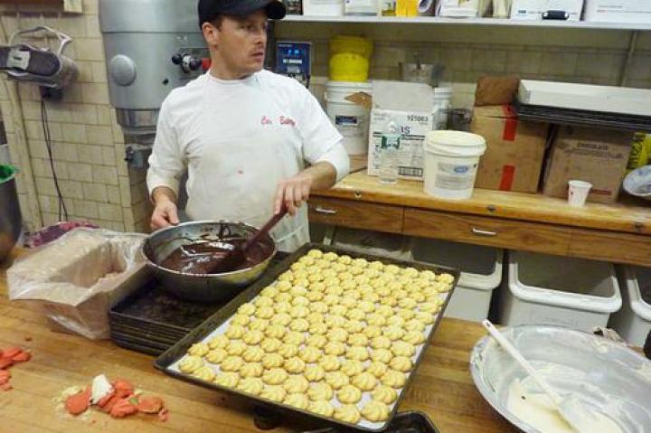 Joey tempers chocolate to drizzle on some holiday cookies.