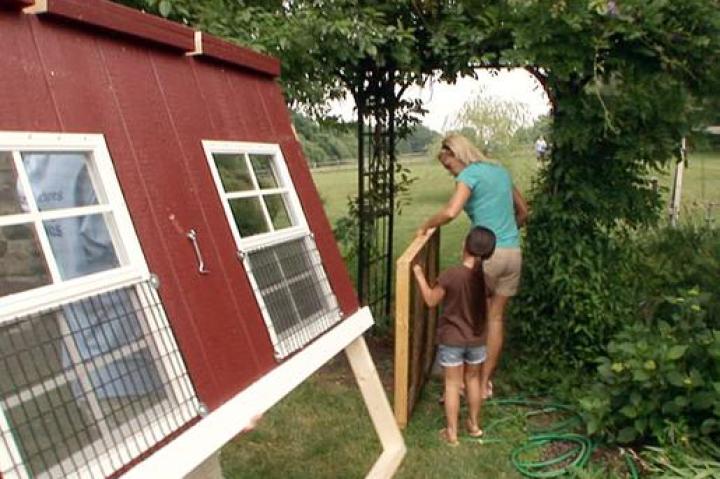 Hannah helps her Mom carry supplies for the chicken coop.
