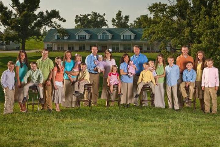 The entire Duggar family in front of their house.