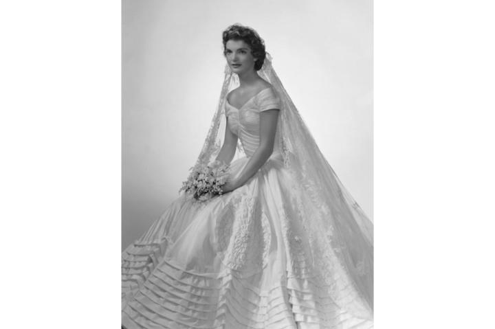 Jackie Kennedy poses for her bridal portrait in her Anne Lowe wedding dress at Bachrach's New York studio in 1953.