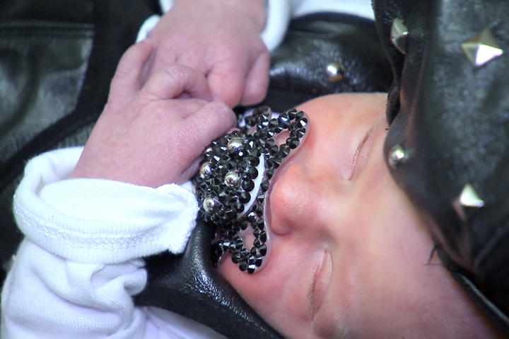 From his studded hat to his black crystal pacifier, Richard is at the height of infant couture.