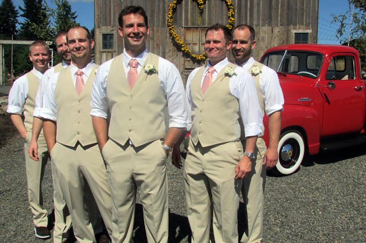 Kevin and his groomsmen wore tan pants and vests with suspenders and coral ties.