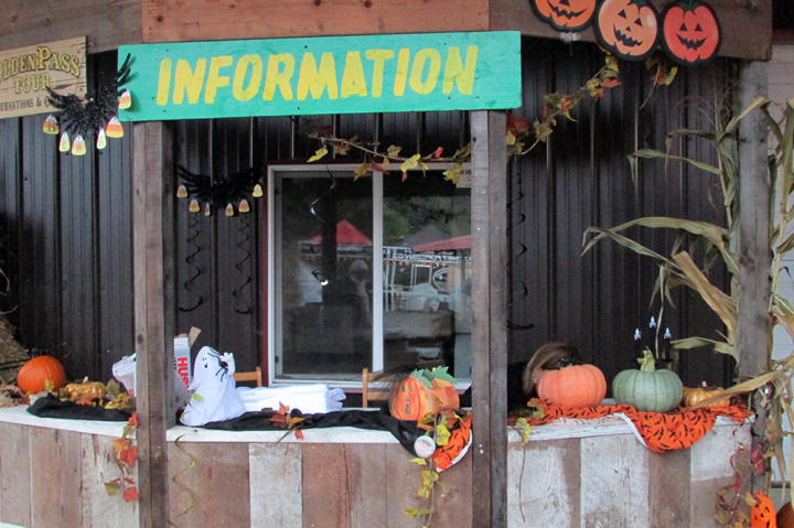 The information booth is festively decorated for Halloween and pumpkin season.