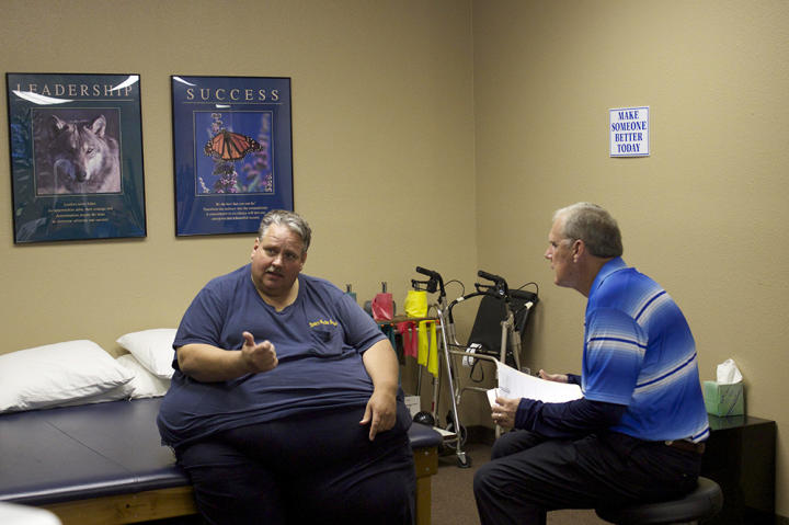 Chuck confers with a specialist at his doctor's office.