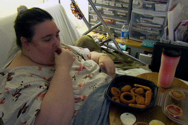 Penny eats a meal in her bed. All of her meals are served by Ed, and he does the grocery shopping from lists that Penny prepares.