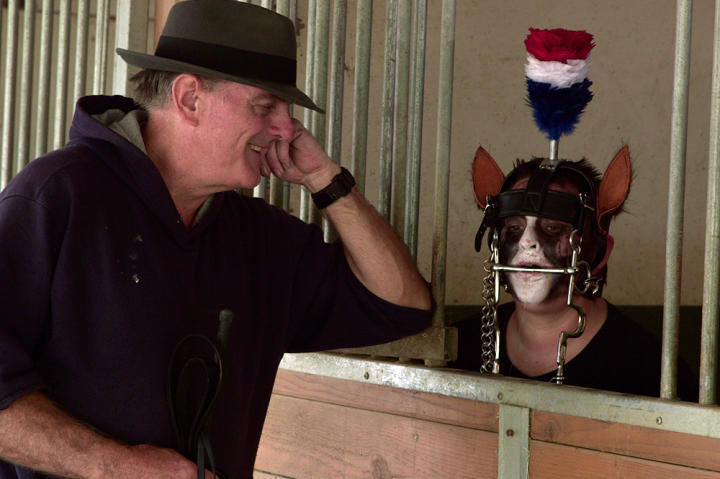 Pony play addict Nicole, waits in the horse stall for her handler to take her out for a walk.