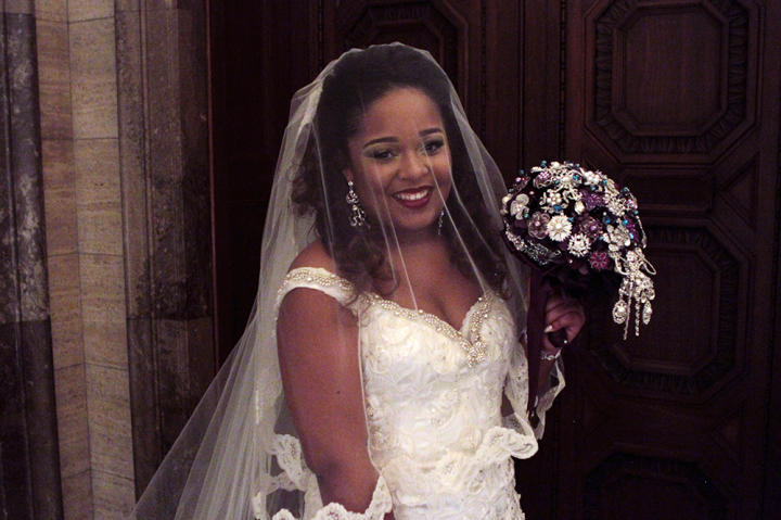 The bride beams at her royal-themed wedding.