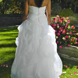 Vanessa in her wedding dress from behind.