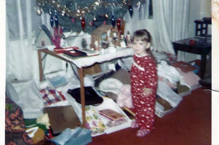 Theresa checks out the tree in an early Christmas photo.