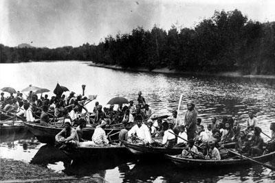 Sea gypsies navigate their boats through a river near Bangkok, Thailand.