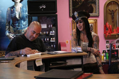 When clients come into Kat’s parlor, they first work through the design concept. In this photograph, from Season 2, Episode 12, Kat talks with Staind frontman Aaron Lewis about what he wants in his tattoo.