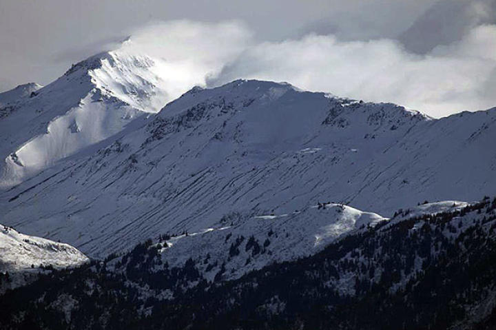 Snow coming off the mountain top.