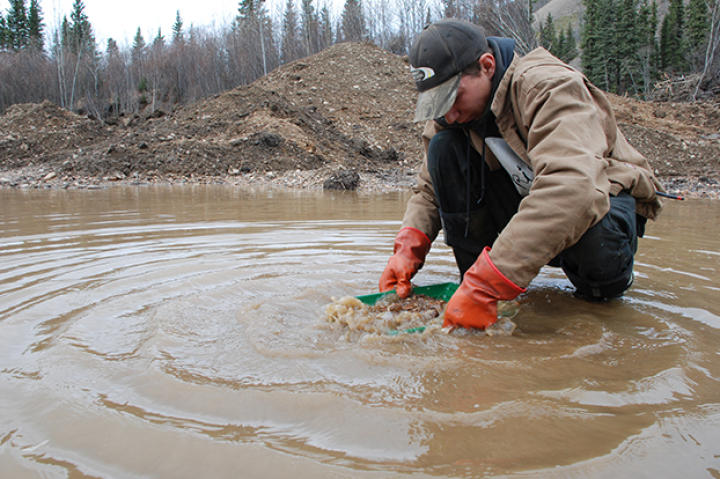 Parker panning for gold on his site.