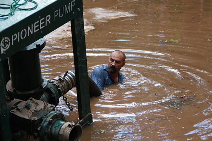 Dave Turin dives into flood waters saving their pump.
