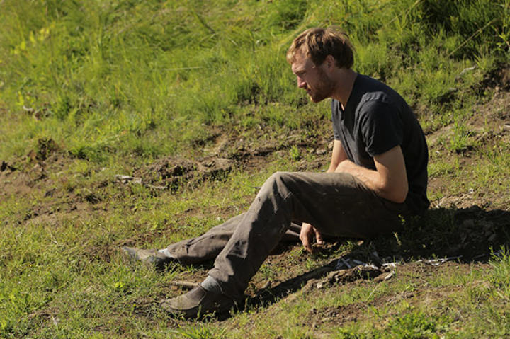 Eivin sits on the ground and takes a moment to gather himself, likely exhausted form the ever mounting work that needs to be done to prepare for the upcoming cold season.