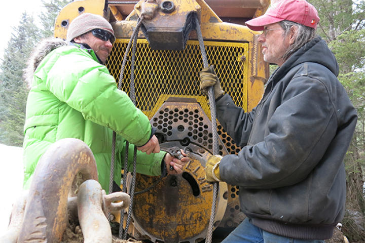 Dustin and Mike work on the aging snowplow.