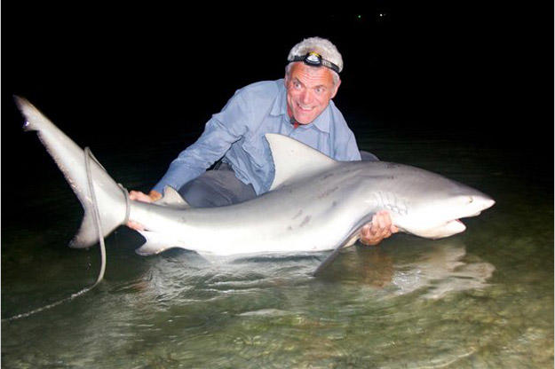Jeremy Wade holds the catch he was really after all along: a bull shark, a species comfortable in both freshwater and saltwater, and responsible for more attacks in the United States than any other shark species.