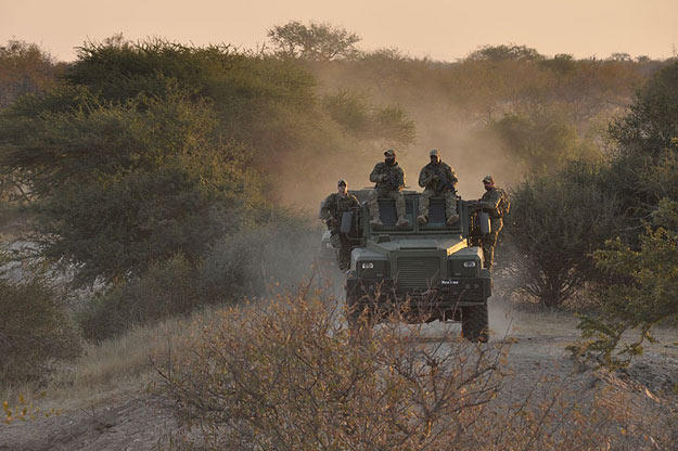 Biggs (Navy SEAL fmr.), Oz (Green Beret), Saw (Navy SEAL fmr.), Rob (Navy SEAL ret.) traveling on Reva vehicle on patrol.