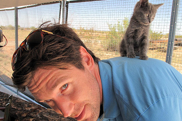 John gives a wee little kitten a boost.