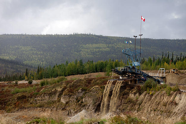 At a claim along the road from Dawson City, a massive wash plant processes multiple tailing streams. Mining operations - past and present - are the most common signs of civilization outside of town.