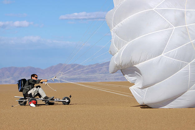 Using his reserve parachute and an improvised buggy, Bear Grylls tries to reserve energy and avoid unnecessary dehydration by using the wind to propel him across a dry lake bed in Arizona.