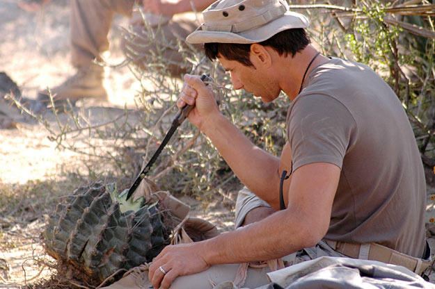 Mykel spends a good portion of the day in the Mexican desert taking cover in the in the shade. He gets much needed fluids from cacti, like this barrel cactus, by cutting them open and sucking out the juices. The remaining cactus pulp is saved for the solar still he and Ruth use to distill every drop of moisture from the fruit.