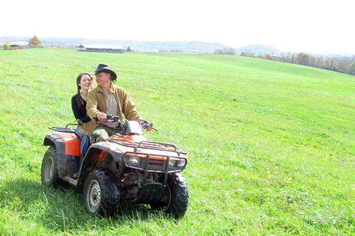 Ernie Brown, Jr., and farmer Cole Henson search the fields for Hugh Heifer.