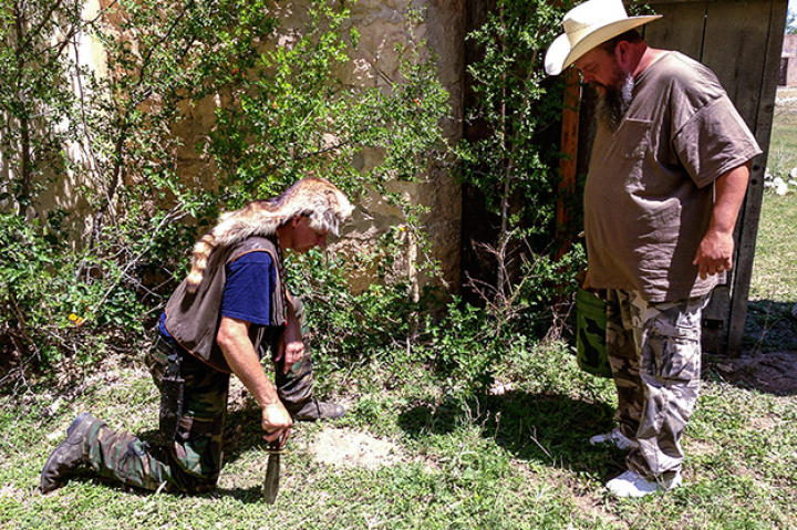 Turtleman and Neal investigate the property surrounding the Alamo Village for potential clues.