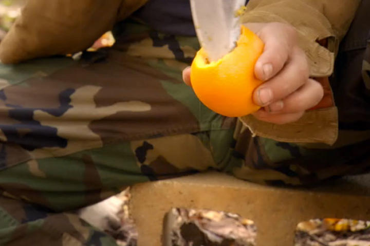 Once you've got your ingredients handy, because, you know - who DOESN'T hike with a couple eggs, an orange and wire - it's GO TIME. Slice the top of your orange and carve out the innards.