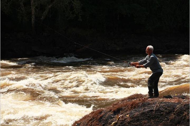 Jeremy Wade casts his line in the roaring Courantyne River, located in northern South America. The raging water flows down from the Acaraí Mountains on the border of Brazil and southern Guyana.