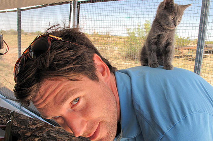 John gives a wee little kitten a boost.