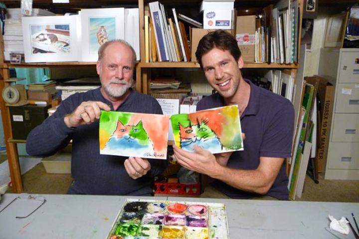 John with Cat Man Drew and a couple of paintings.