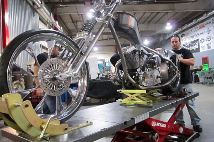 Joe Puliafico helps Paulie with the FIST bike's fender. With its reverse curves, biometric readers, front-end configurations and 26-inch wheels, the FIST Bike was a complicated build.