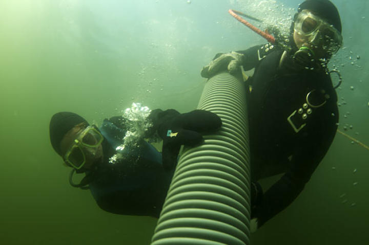 Emily and Zeke prospect together with the Clark's 30-foot suction hose.