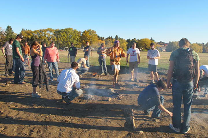 Cody teaches outdoor education university students how to light a fire with wet fuel, Washington State, 2010.