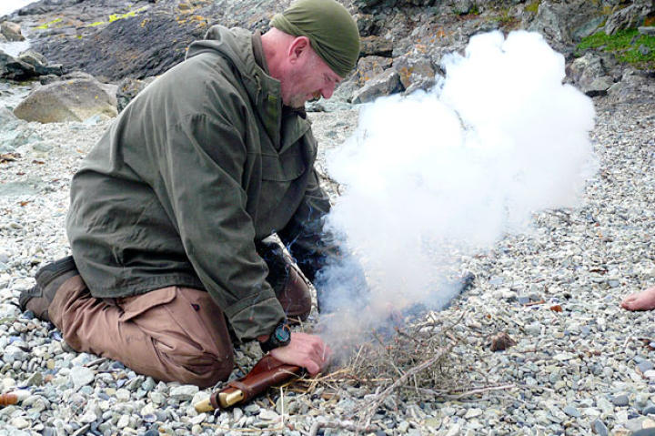 Dave shows how to get a fire going with the sparking percussion action of a black powder rifle.