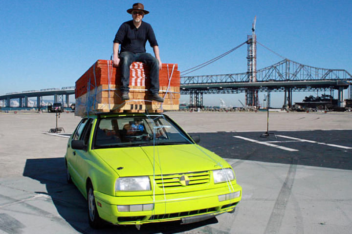 Adam Savage perches atop the Lumber Car, which he and Jamie used to test whether a do-it-yourselfer really could have loaded his vehicle with 3,100 pounds of building materials — and then drive home.