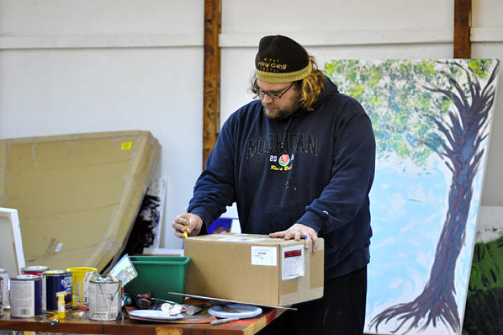 Mikey opens a package in the back of his gallery. If memory serves, it was some sort of paint sprayer.