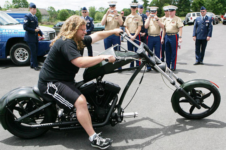 Mikey Teutul drives the Comanche Bike at a 2006 OCC cook-out with servicemen.