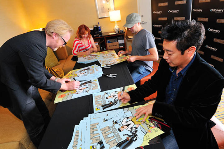 Adam Savage, Kari Byron, Tory Belleci and Grant Imahara sign the limited-edition MythBusters Comic Con poster before their panel.