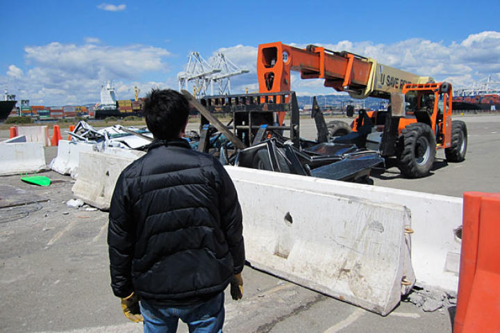 As Grant Imahara looks on, Tory Belleci uses a crane to hoist one of the "Surf and Turf" test cars. Did