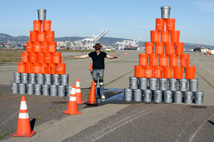 In the "Fixing a Flat" race, Adam Savage thought his manhole-cover tires would out-perform Jamie Hyneman's steel rims. He was wrong. He would soon be crashing the water pyramid on the right like it was invisible.